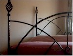 Wrought iron bed featuring corner posts